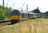 A Barrhead travel company has this year organised rail charters between Glasgow and Southampton in connection with cruises from the port. On 14 July 2012 a return service is seen across the overgrown southern end of platforms 2 & 3 at Leyland with DBS 67005 <I>Queen's Messenger</I> heading a converted Mk 1 vehicle for luggage and a mixture of Mk 2s featuring Anglia and Virgin colour schemes.<br><br>[John McIntyre 14/07/2012]