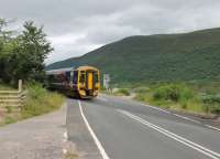 158715 on a Kyle to Inverness service crosses the A890 at Balnacra between Strathcarron and Achnashellach. A railwaymen's halt was located here at one time but no public station.<br><br>[Mark Bartlett 07/07/2012]