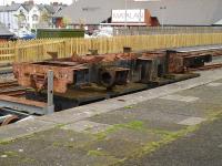 The frames of Vale of Rheidol No 7 <I>Owain Glyndwr</I> sit on a flat wagon alongside the former standard gauge platform 1 at Aberystwyth on 10 May 2012. The cargo is awaiting completion of the new Vale of Rheidol Railway heavy maintenance works before rebuilding can start in earnest. <br><br>[David Pesterfield 10/05/2012]