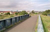 A 1997 view south from the 'new' girder bridge at Crew Junction with the former line to Granton on the left and to Leith North on the right, both long closed. In the left background are the gasometers at Granton [see image 26659].<br><br>[Ewan Crawford //1997]