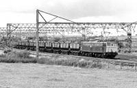 76 051 with a train of empties passing Penistone on 17 July 1981 heading for Rotherwod Sidings. In the background are Barnsley Junction sidings which contain a rake of MGR coal empties (probably destined for Dodworth colliery) and 76 022 on a Sheffield bound train of scrap.<br><br>[Bill Jamieson 17/07/1981]
