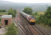<I>Rise and Shine</I>. The Inverness portion of the northbound Caledonian Sleeper comes off the viaduct over the River Nairn and runs through closed station of Culloden. 67017 is on the very last leg of the long journey and will soon be in Inverness. <br><br>[Mark Bartlett 04/07/2012]