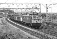 After being held in the loop at Barnsley Junction, 76022 now heads towards Sheffield with a load of scrap in unbraked 16T mineral wagons. The train is the 12.00 from Dewsnap Sidings on 17 July 1981, reporting No. 8E11 [with thanks to Rob Barnes].<br><br>[Bill Jamieson 17/07/1981]