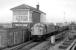 40135 draws its train of empty cartics past Bathgate Central signal box in December 1983. No track survived on the other side of the signalbox by this time. [See image 39045]<br><br>[Bill Roberton 08/12/1983]