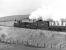 LNWR Precedent class 2-4-0 No. 790 'Hardwicke' and the Midland Compound No. 1000 head towards Clapham with the Gainsborough Model Railway Society special of 24th April 1976. Although sunny the day was rather hazy so that the fine Dales scenery in the background is barely visible.<br><br>[Bill Jamieson 24/04/1976]