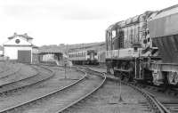 08761 stands in Markinch Yard with the Thornton - Auchmuty (Tullis Russel) trip in June 1990. The locomotive had failed with a generator fire. In the background a class 150 boards at the southbound platform. The former goods shed in the left background was, for some time, the home of preserved A4 Pacific no 60009 <I>Union of South Africa</I> [see image 22374].<br><br>[Bill Roberton 05/06/1990]