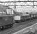 76022 heads through Penistone towards Sheffield in July 1981 with a train of scrap from Dewsnap Sidings in Dukinfield. Meantime 45001, employed that afternoon on trip workings between Penistone and Dodworth Colliery, is about to shunt a half-load of power station coal into the sidings at Barnsley Junction.<br><br>[Bill Jamieson 17/07/1981]