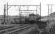 37070 passes Wombwell Main Junction at 07.25 on 17 July 1981 and takes the branch for Barrow Colliery where its load of empty HAA hoppers will be replenished. The branch was the northern remnant of the erstwhile South Yorkshire Railway's Blackburn Valley Line which had at one time run through to Wincobank, Sheffield. The electrified line to Penistone curving off on the left had less than 24 hours of active life left although the official closure date was probably the following Monday.<br><br>[Bill Jamieson 17/07/1981]