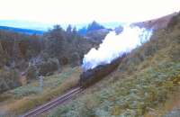 By Huntly's Cave, around 2 miles north of Grantown-on-Spey, near Castle Grant Platform, an unidentified Black 5 fights its way up the 1 in 80 gradient towards Dava Summit in the early 1960s.<br><br>[Peter Oliver Collection (Courtesy David Spaven) //]