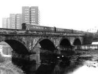 A train from Glasgow Central crossing the River Ayr on the approach to Ayr station in March 1972.<br><br>[John Furnevel 02/03/1972]