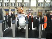 <i>'Oops... breathe in!'</i> Sandy the Squirrel negotiates the platform entry gates at Aberdeen on 30 November - see news item. <br><br>[First ScotRail 30/11/2011]