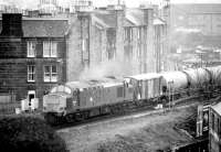 A southbound cement train crossing the bridge over Gorgie Road and approaching the site of Gorgie East station on the Edinburgh sub on 14 April 1981.<br><br>[John Furnevel 14/04/1981]