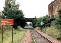 Looking towards Powderhall and the 'destructor' from the west end of the former Leith Walk station on a Sunday morning in August 1999. Part of the abandoned Shrubhill tram depot stands on the right.<br><br>[John Furnevel 15/08/1999]