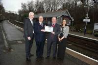 The platform presentation of the Platinum award at Whitecraigs station on 5 January 2012. [Left to right Steve Montgomery, Gary MacIntyre, Derek Robertson and Elaine Bell] [See news item].<br><br>[First ScotRail 05/01/2012]