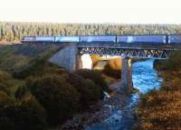 The Inverness portion of the Caledonian Sleeper catches the morning sun as it crosses Carrbridge Viaduct over the River Dulnain on 12 September 2004.<br><br>[John Furnevel 12/09/2004]