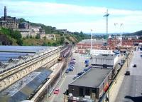 Looking east from the top deck of a bus on North Bridge in June 2005. A Virgin Voyager is approaching platform 20 from the Calton Tunnel with a Cross Country service off the ECML. Phase 1 of the Waverley Valley development is underway between East Market Street and the station - the new Edinburgh Council HQ is starting to take shape, while the soon-to-be-demolished bus depot in New Street still forms the far side of the triangle.<br><br>[F Furnevel 01/06/2005]