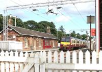 Looking east over the platforms at Cardross from the level crossing in July 2005, with a train for Airdrie about to depart.<br><br>[John Furnevel 27/07/2005]