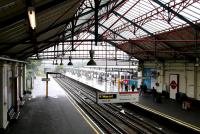 Looking out from the old trainshed along District Line platform 9 at Ealing Broadway in July 2005. This being a particularly wet day the external platforms are in use!<br><br>[John Furnevel 20/07/2005]