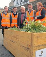 Great Gardens volunteers Lee Ewens, Ross Connelly, Iain Borthwick and Angela Christie with ScotRail's external relations manager John Yellowlees (centre) with one of the new raised planters at Queens Park station.<br><br>[ScotRail 30/03/2012]