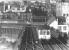 A 1975 view from the footbridge at Gateshead East station across Robert Stephenson's double deck High Level Bridge. The lower level carries a road and a pedestrian walkway, which can be clearly seen bottom left - including the section vaulted by Michael Caine while making his escape in the 1971 film <I>'Get Carter'</I>. The Castle Keep stands in the right background. [See image 18934]<br><br>[John Furnevel 20/10/1975]