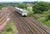 Looking east towards Greenhill Lower Junction in June 2004. A DMU heading for Glasgow Queen Street is about to run through the site of Greenhill (Lower) station (closed April 1966). [See image 6666]<br><br>[John Furnevel 15/06/2004]