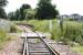 The platform remains at Kincardine station in June 2005. View southeast over the level crossing, with the Kincardine Bridge in the right background. The crossing gave access (right) into the yards of the now demolished Kincardine power station.  <br><br>[John Furnevel 02/06/2005]