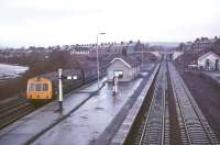 Scene at Haltwhistle station on a rainy morning in 1975 looking west towards Carlisle. A 2-car DMU has recently arrived with a service off the Alston branch.<br><br>[Ian Dinmore //1975]