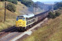Class 31 No. 5690 trundles along between Foxlow Junction and Barrow Hill in September 1971 with the 1155 Wath to Toton. The loco sports a hybrid livery of green with corporate logo which, from my own observations, was by no means unusual for the later members of this class.<br><br>[Bill Jamieson 20/09/1971]