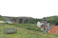 A disused Moray Coast bridge and one of the town's viaducts that form part of the impressive railway backdrop to the coastline at Cullen. <br><br>[Mark Bartlett 03/07/2012]