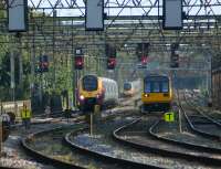 A northbound Voyager and a Class 142 crossing the River Ribble bridge together on the southern approach to Preston station on 5 September 2012. Between them in the distance is a southbound Pendolino making for its next port of call at Wigan North Western.<br><br>[John McIntyre 05/09/2012]