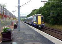 The 11.53 Largs - Glasgow Central runs into the attractively decorated platform at West Kilbride on 12 September.<br><br>[Colin Miller 12/09/2012]