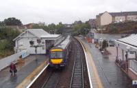 A dreich day in Fife on 20 September 2012, as the 12.33 departure for Edinburgh Waverley restarts its journey south from Inverkeithing station.<br><br>[Andrew Wilson 20/09/2012]