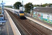 The 13.30 ex-Waverley speeds through Prestonpans station on 19 September 2012 on its 4 hour 26 minute journey to Kings Cross. The train is about to run past the impressive mural created by artist Adele Conn a year earlier [see image 4963].<br><br>[John Furnevel 19/09/2012]