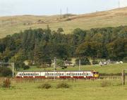 A Helensburgh Central - Edinburgh Waverley service approaches Ardmore East level crossing in the afternoon sunshine on 22 September 2012.<br>
<br><br>[John McIntyre 22/09/2012]