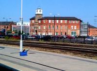 The entrance building is one of the few remaining parts of the Midland's Derby Works, and one of the few which can be seen from the station. The building, seen here in September 2012, has been renovated and updated with modern extras: truly 'old meets new'. Notice the high-tech wash equipment on the platform.<br><br>[Ken Strachan 15/09/2012]