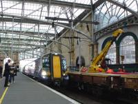 Two four-car 380s arrive at Glasgow Central ecs on 27 September to form the 15.30 service to Ayr. Platform 15 is having new platform edging installed. <br><br>[Colin Miller 27/09/2012]