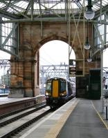 Grand entrance. The 10.36 ex-Gourock runs through the arch into Glasgow Central on 28 September 2012. The two platforms accessed via the arch were created in 2009, displacing the former station car park. They were originally intended to cater for trains on the Glasgow Airport Rail Link. <br><br>[John Furnevel 28/09/2012]