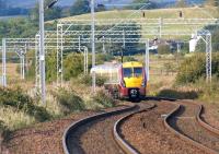 Looking west from Ardmore East level crossing on 22 September 2012 as 334016 heads towards Craigendoran and ultimately Helensburgh Central.<br><br>[John McIntyre 22/09/2012]