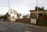 View east from the level crossing at Insch on 16 October 2012 with the signalbox and water tower standing guard on either side of the track. A station totem has appeared on the west side of the water tower.<br><br>[John McIntyre 16/10/2012]