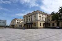 The main building at Krakow Glowny originating in 1844 - 47 and still in use containing the waiting rooms, booking halls, etc. The replacement in the modern building (a shopping centre) in the background is behind schedule. The old station will then become a gallery, etc. Its solitary platform is fenced off and access to the other platforms, which are not adjacent, is via subways from the new building. <br><br>[Colin Miller /08/2012]