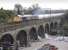 GBRf 66735 accelerates away from a signal check at Slateford Junction on 2 October and crosses the Water of Leith viaduct with the 6S45 North Blyth - Fort William Alcan service.<br><br>[Bill Roberton 02/10/2012]