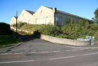 The shell of the roundhouse of the former Tweedmouth locomotive shed looking north west from Billendean Terrace in October 2012. Access is no longer possible from here, with padlocked metal gates blocking the top of the ramp opposite. Most of the site now forms part of a building supplies operation, with access from the north west via the A1167 Northumberland Road. Tweedmouth shed was officially closed by BR in June 1966. [See image 42108]<br><br>[John Furnevel 07/10/2012]