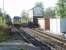 The 4-aspect colour light signals at Huyton are controlled from the mechanical lever frame in the LNWR signal box. New infrastructure is appearing however, as seen here, and the box will not survive the forthcomng electrification. 142025 is on the rear of a four-car Pacer set leaving for Liverpool Lime St. <br><br>[Mark Bartlett 17/10/2012]