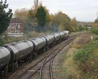 The MWF only bitumen empties for Lindsey refinery are wheeled east through Lostock Hall Junction by DBS 66204. The lines in the foreground lead to the WCML at Farington Junction and the locomotive is just passing the point where the chord to Todd Lane Junction and Preston E.L. left this line until final closure in 1972. [See image 31876] for the same location in 1981.  <br><br>[Mark Bartlett 31/10/2012]