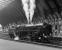 The curved trainshed at York forms a magnificent backdrop to 9F No. 92220 <I>Evening Star</I> blowing-off impatiently as it waits to take over the Scarborough Flyer excursion in July 1976. The train started its journey from Newcastle round the Durham coast behind Stephenson valve gear Black 5 No. 4767, with class 40 diesel power taking over at Stockton for the second leg along the ECML.<br><br>[Bill Jamieson 04/07/1976]