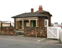 Entrance to the 1848 station at Leeming Bar with its unique Italianate pillared portico. The station was closed to passengers by BR in April 1954, but is now the headquarters of the Wensleydale Railway. View west over the old A1 road on 9 July 2012 with the level crossing on the right. <br><br>[John Furnevel 09/07/2012]