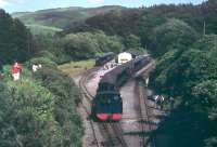 Panorama of the terminus at Devils Bridge in the early 1970s, taken from the overbridge at the station throat. No.8 <I>Llewellyn</I> has just run round its train of six coaches while two others wait in the sidings, probably to be added in to the last train of the day. Loco and coaches are all in BR Blue with the double arrow symbol. <br><br>[Mark Bartlett //1972]