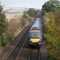The 12.07 First Scotrail Class 170 Aberdeen - Edinburgh approaches Fordoun on 20 October 2012. Photographed from the road bridge alongside the station site [see image 40838] looking north east towards the Network Rail track access point in the middle distance. <br><br>[John McIntyre 20/10/2012]