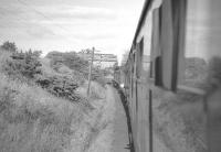 View from a carriage window of the RCTS (West Riding Branch) <i>Borders Railtour</i> near Coldstream on 9 July 1961. NBR 4-4-0 no 256 <I>Glen Douglas</I> + J37 0-6-0 no 64624 are taking the special as far as Tweedmouth, where A1 Pacific no 60143 <I>Sir Walter Scott</I> will take over for the journey south to Newcastle via the ECML. [See image 30192]<br>
<br>
<br><br>[K A Gray 09/07/1961]