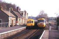 An HST en route to Barnstaple passes a local DMU at Eggesford on 18 March 1990.<br><br>[Ian Dinmore 18/03/1990]